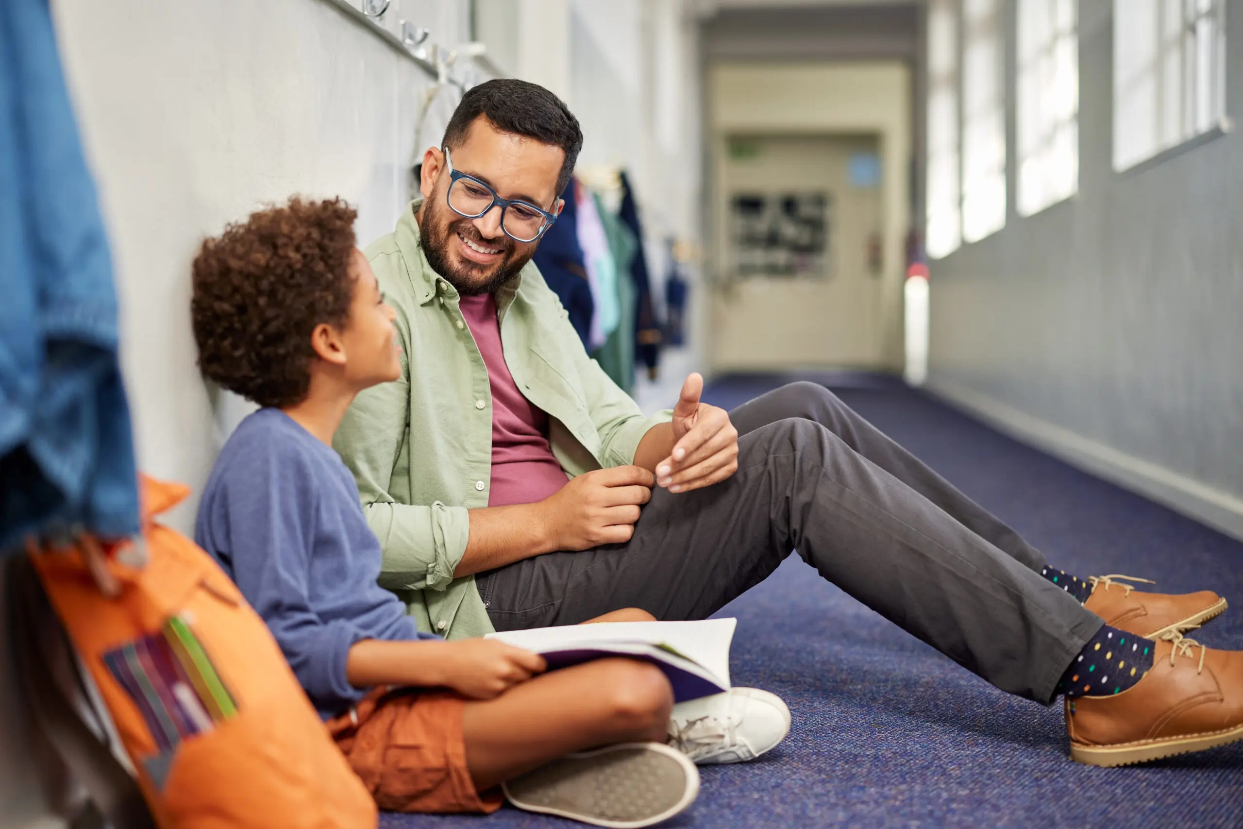 adorable-hispanic-boy-smiling-happy-playing-at-the-2026-03-26-09-47-51-utc An adult and child reading together at school
