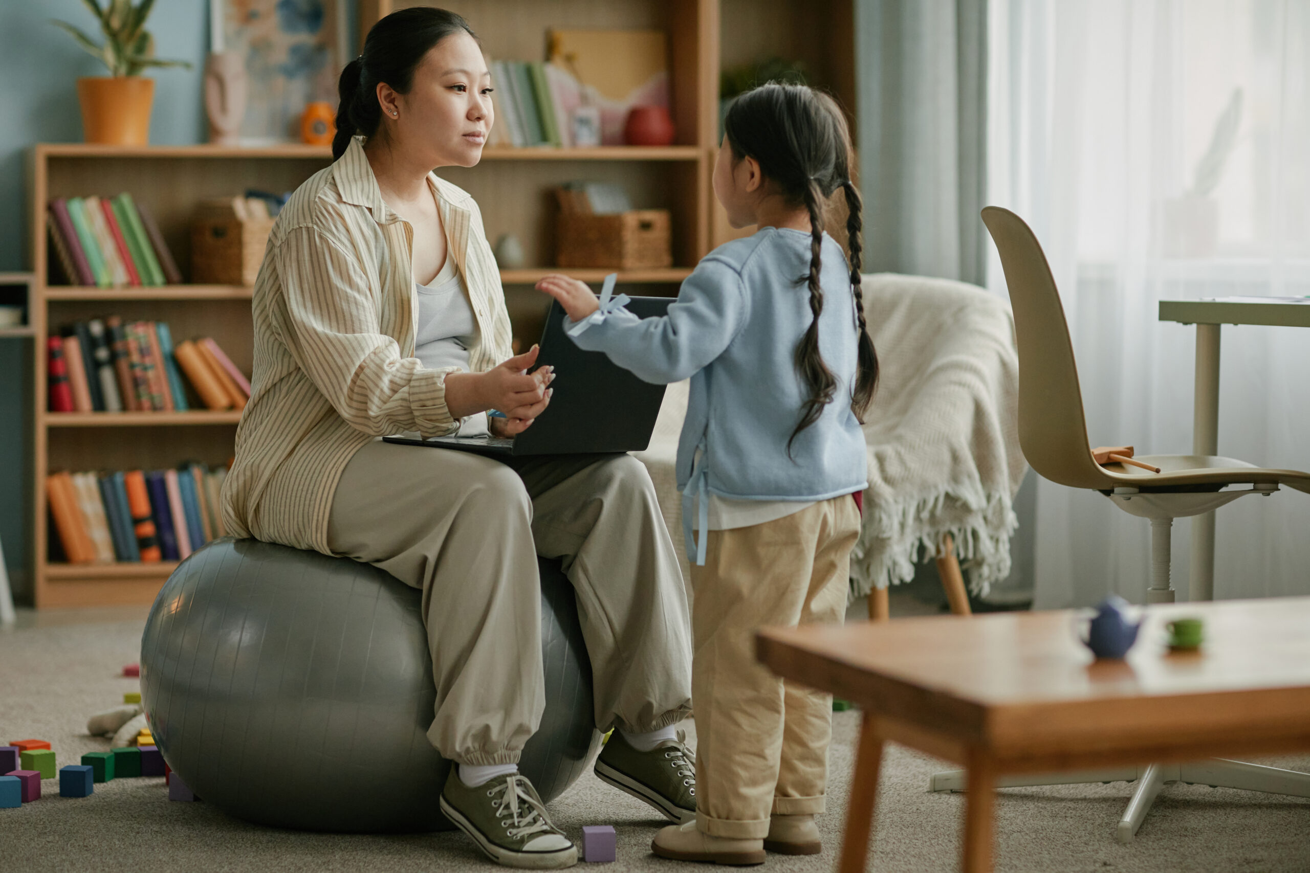 An adult and child reading together at school